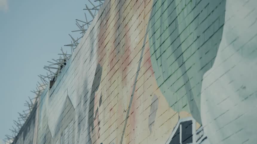 A painted mural decorates a tall wall