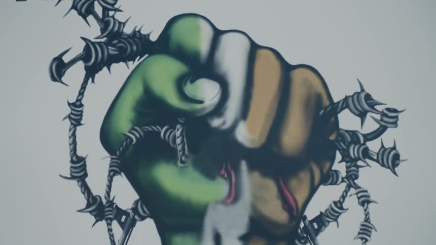 A nationalist mural in ulster reads irish republican with a fist clenched in the colors of the tricolour