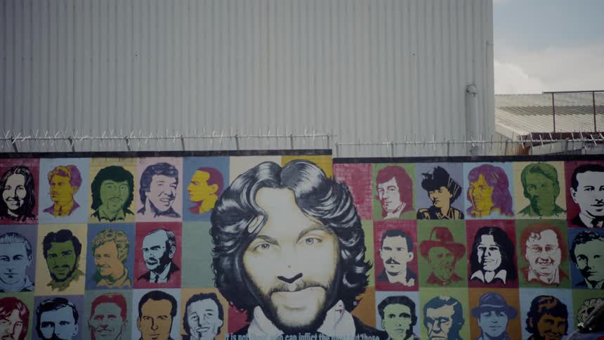 A painted collage wall mural along the street