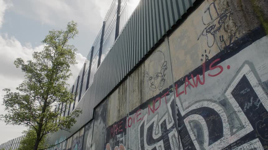 A peace wall in northern ireland read make love not laws