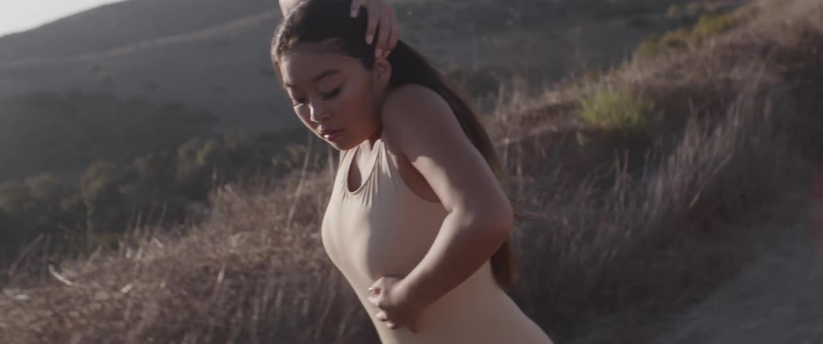 A woman performs modern dance in an outdoor area