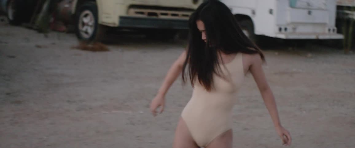 Woman dances outdoors in parking lot