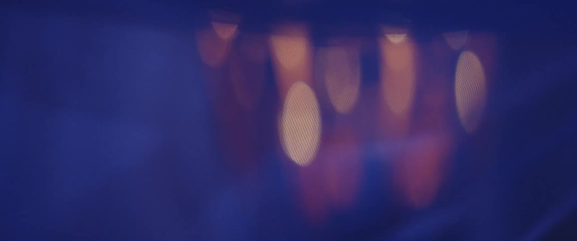 Spots of light shining through a transparent curtain