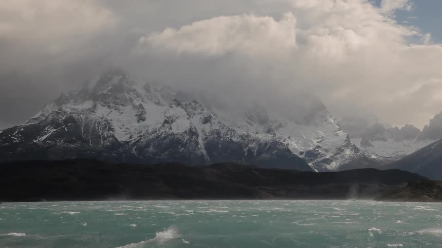 The ocean with mountains and the sky in the background