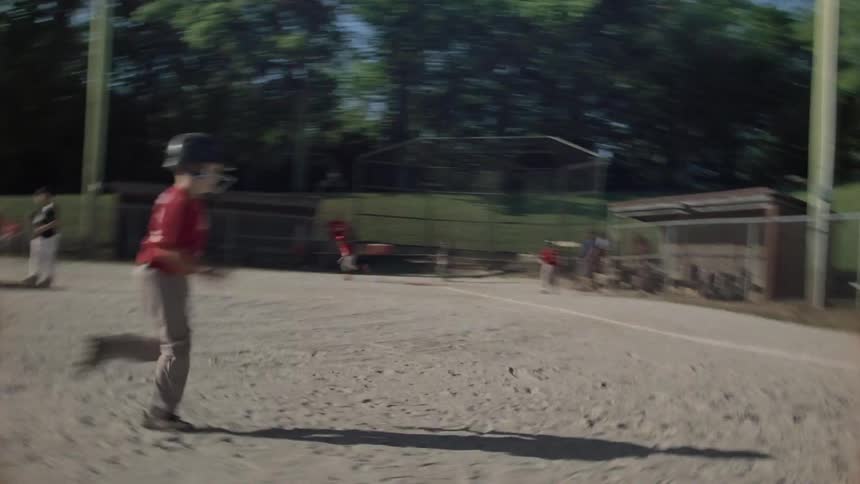 Player runs and slides to base