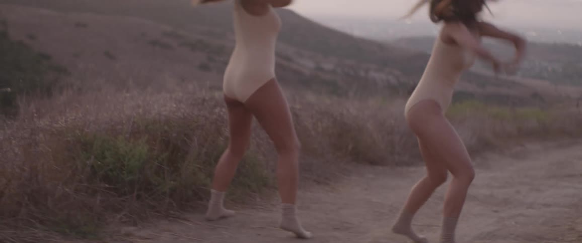 Two asian women dance together