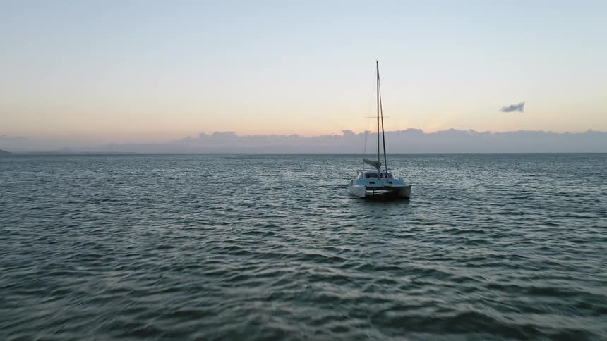 A sailboat floating on the ocean