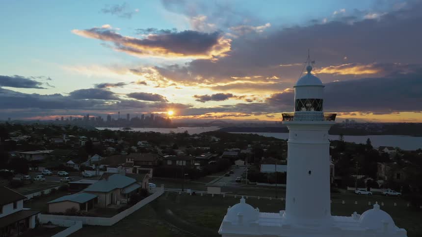 A birds eye view of a tall white religious building on a sunny day at sunrise