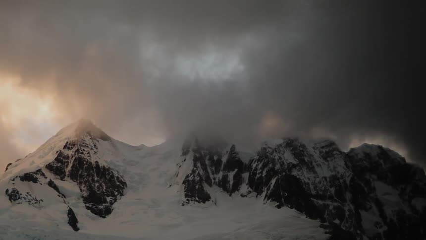 Snow and cloud covered mountain peaks