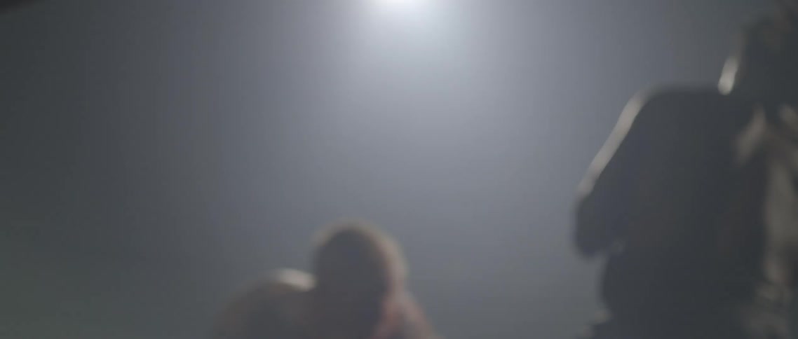 White boxer spars with black boxer and hit each other in the ringon the dark background