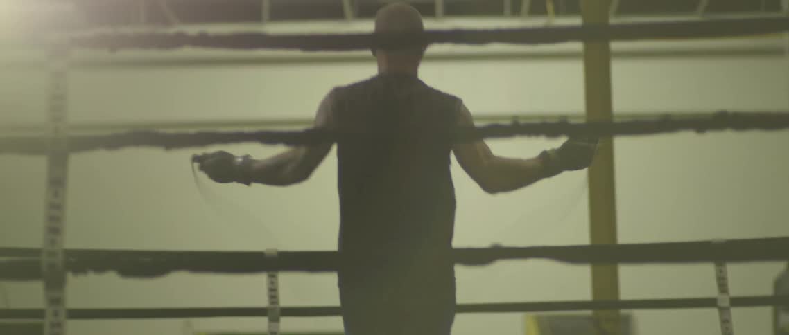 A man jump ropes in a boxing ring