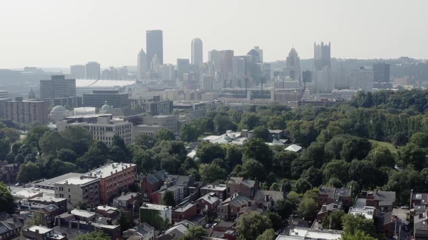 A birds eye view of a cityscape skyline on a cloudy day