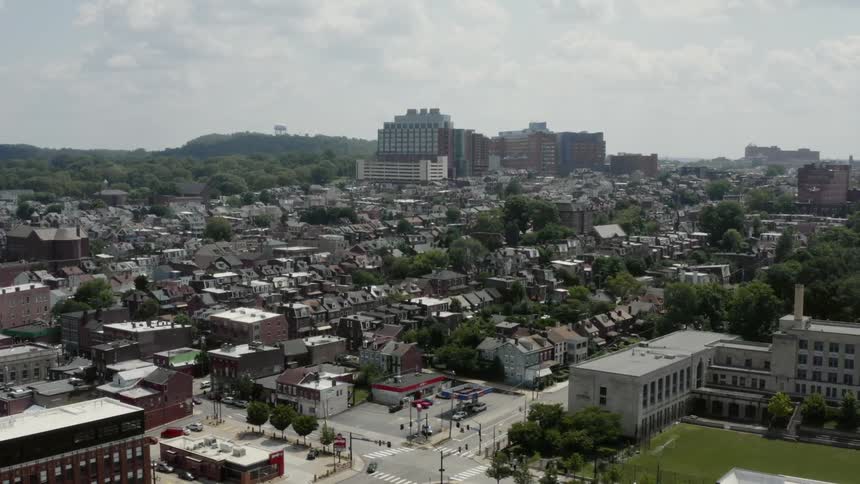 An aerial view of cars driving through a downtown city