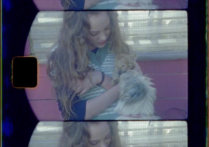 A female is holding a cat and a dog is by them