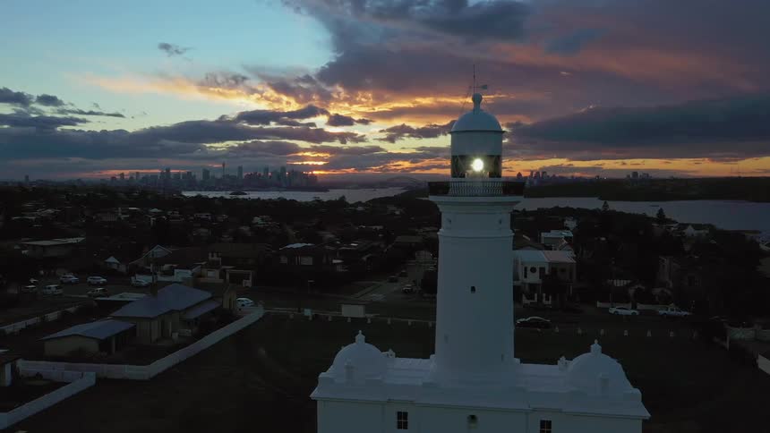 A colorful sunset hangs over a large city