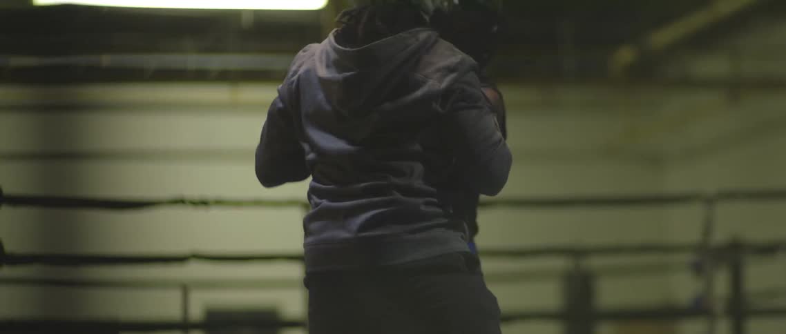 Boxers sparring on the ring in a gymnasium