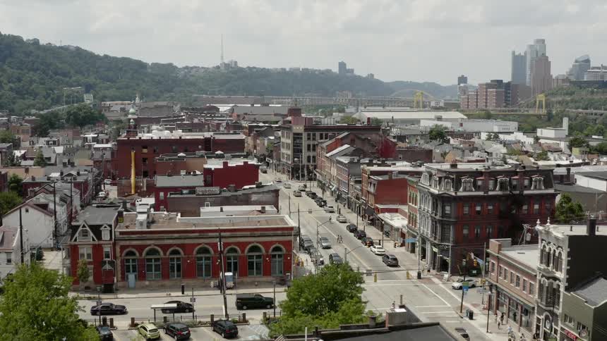 Cars are driving in a city during daytime