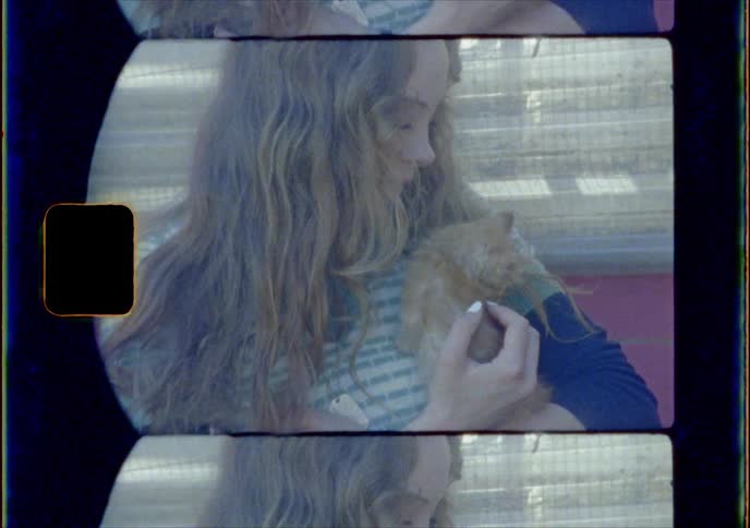 Video of a young girl holding a kitten
