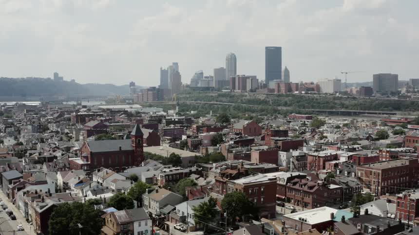 A city with many red brick buildings during the day