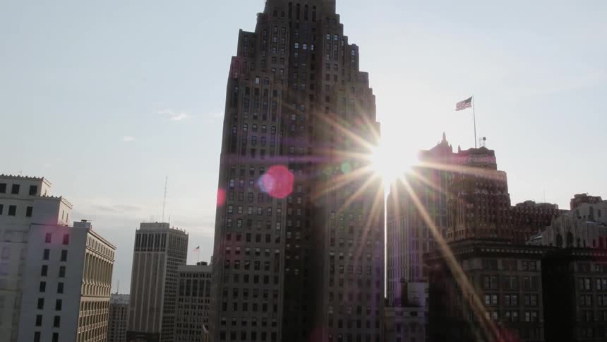 A skyscraper looms over surrounding buildings