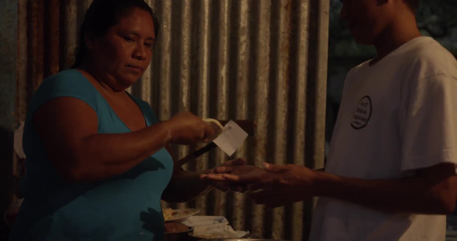 A man and a woman prepare dough for cooking