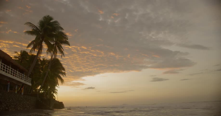 A house on the oceans edge during sunrise