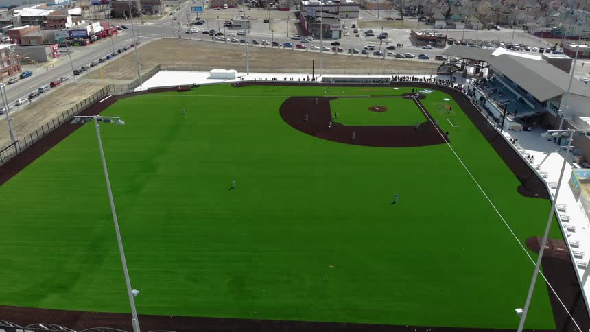 A baseball diamond and stands on a street corner