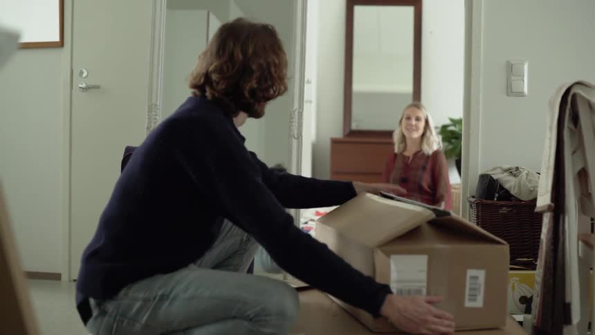 A man and woman are organizing their home