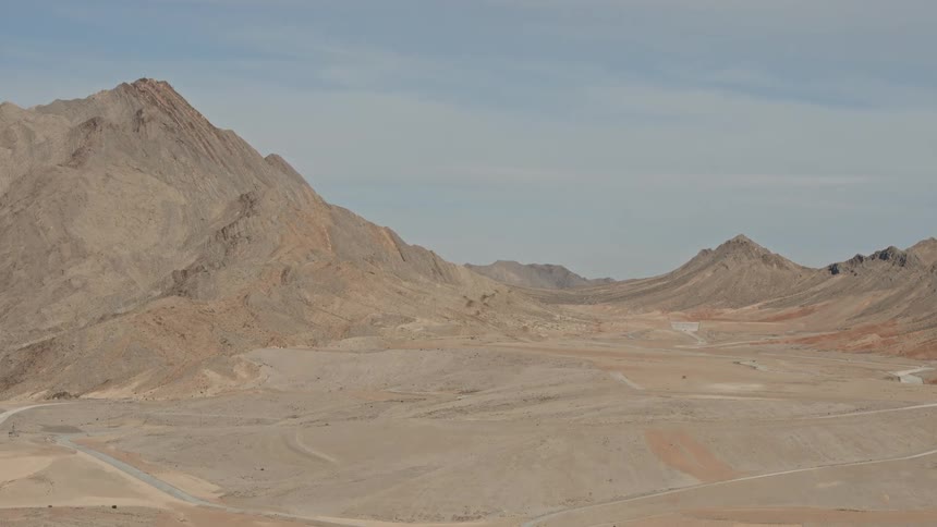 The hills are in the distance in the desert