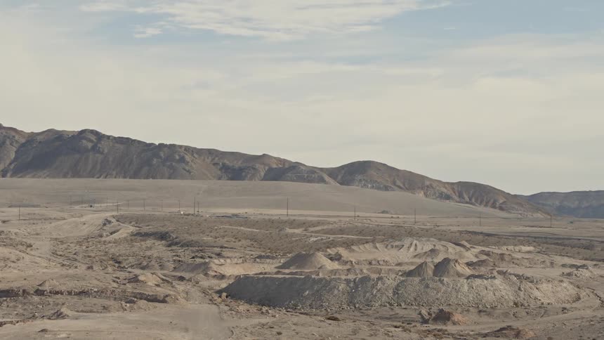 The desert is full of hills on a cloudy day