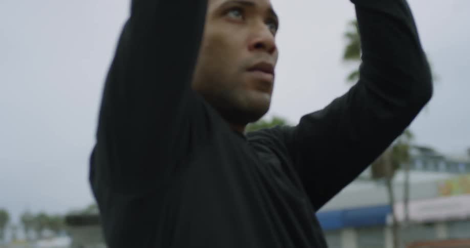 Man shoots a basketball in a court on a park