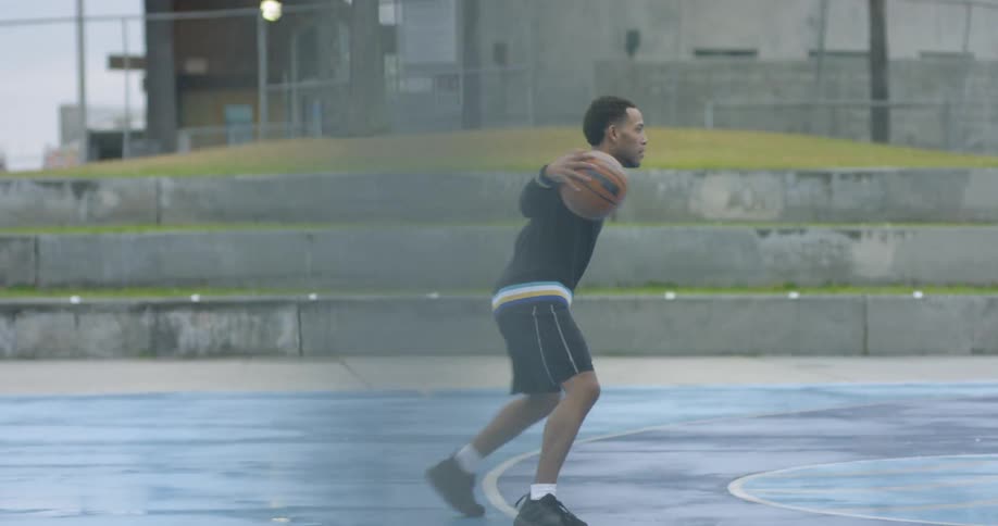 A man is spinning around dribbling the ball on the court
