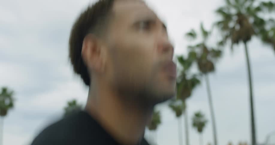 Man jumps and tosses a basketball outdoors