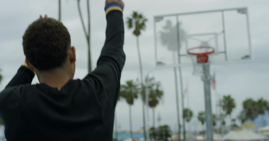 A man shoots the basketball into the hoop