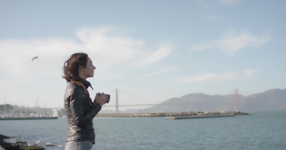 Woman takes a photo while looking over the bay