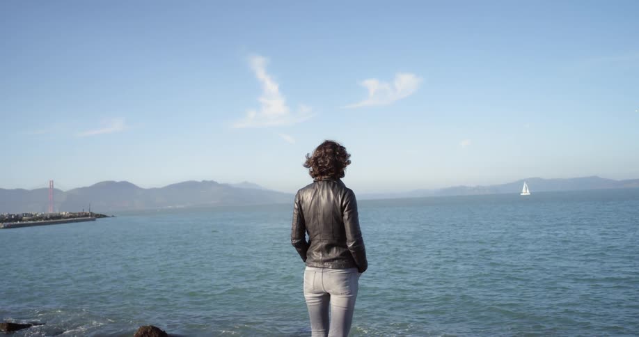 A woman looking off into the ocean