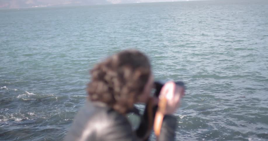 Woman takes pictures of the ocean