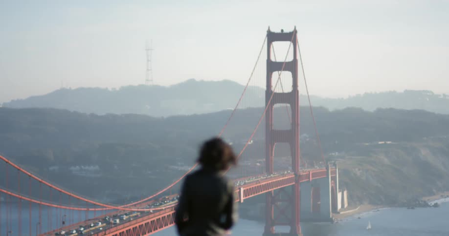 A woman looking at the golden gate bridge