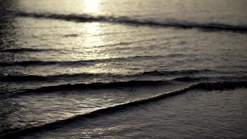 Ocean Waves Washing Ashore on Sandy Beach Under Bright Daylight Coastal Nature Footage.