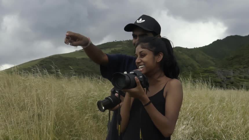 People Photographing a Scenic Natural Landscape, Capturing Trees, Sky, and Wilderness.