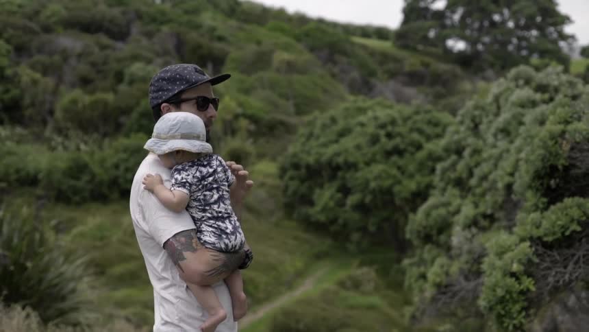 A Man Holding His Baby Outside, Sharing Love, Protection, and Fresh Air.