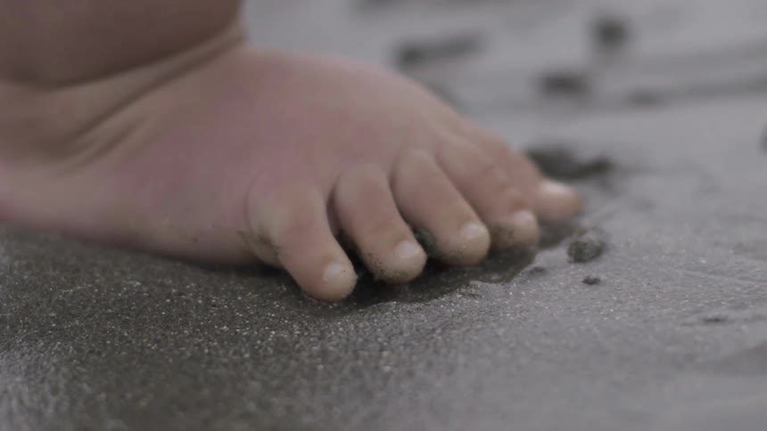 Little Feet Walking on Sandy Beach, Embracing Innocence and Summer Calm.