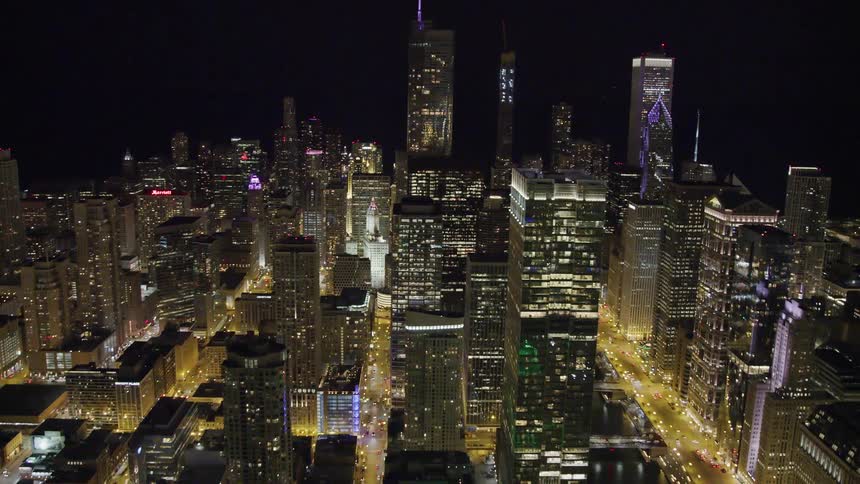 Skyline of the illuminated city with skyscrapers and tall buildings at night
