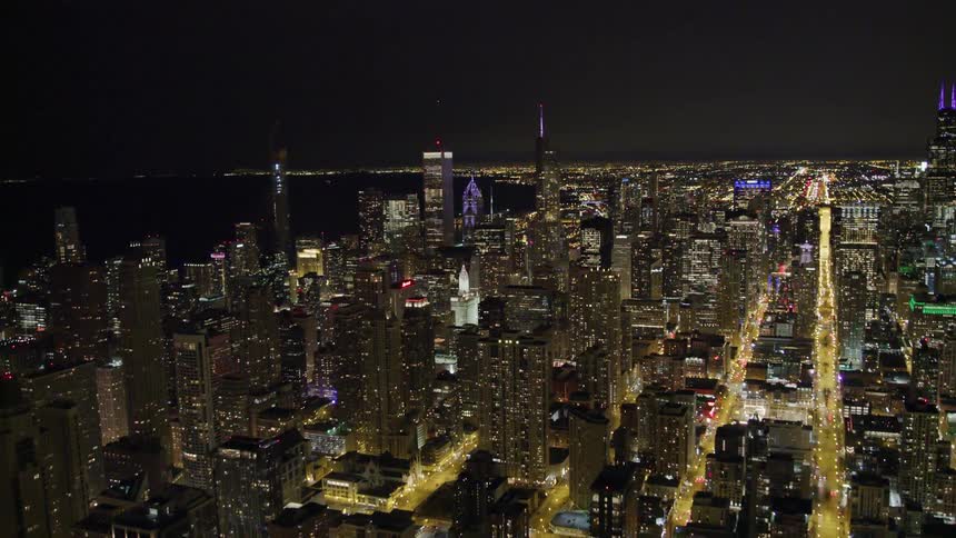 A large city skyline lit in the night sky