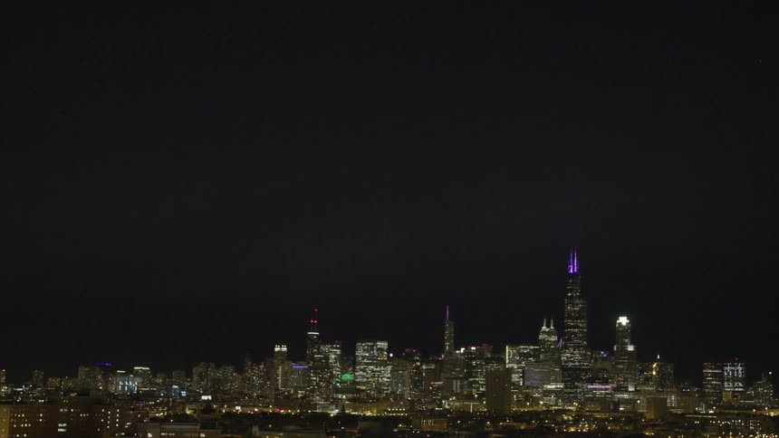 City skyline lights glow and shimmer at night