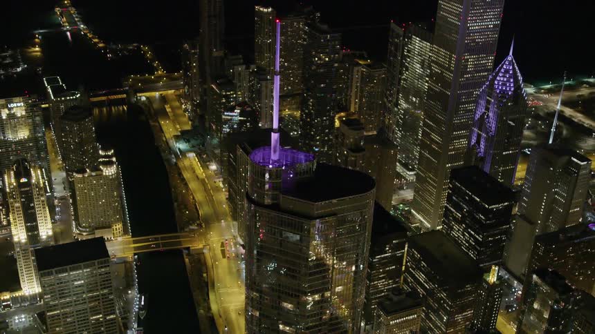 An aerial view of city skyscrapers and lights at night