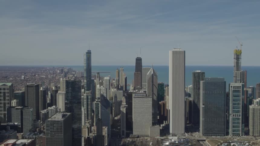 A city skyline with the ocean and the sky in the background