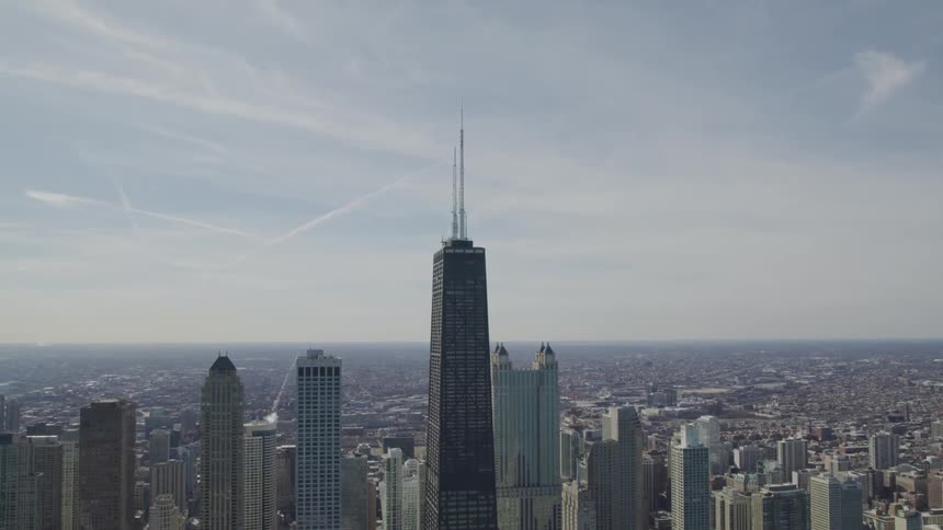 Skyscrapers and buildings sit in the city under the blue sky