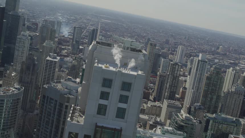 A gray skyscraper in a large metropolis during the day