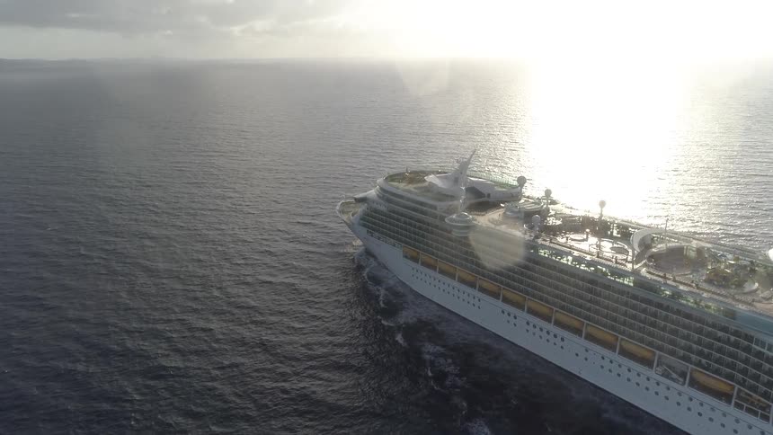 An aerial view of a cruise ship sailing on an open ocean